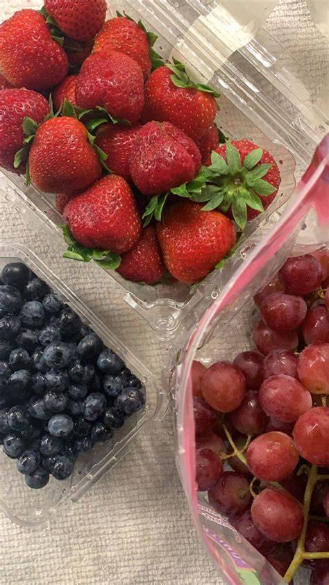 Washed berries are portioned into small containers for easy evening snacking.