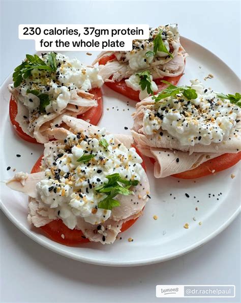 Cottage cheese, cucumber slices, and cherry tomatoes fill a small protein snack plate.